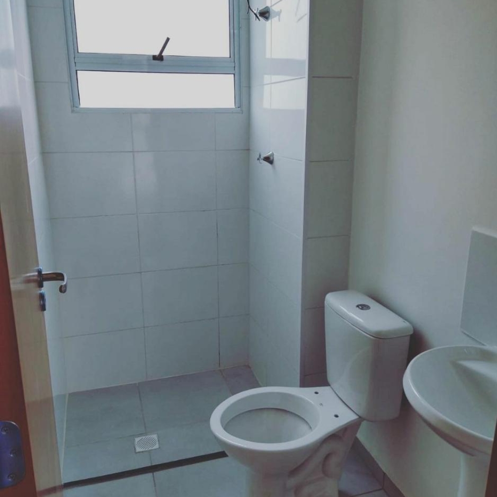 Outdated bathroom before renovation with old tiles, old fixtures, and faded walls