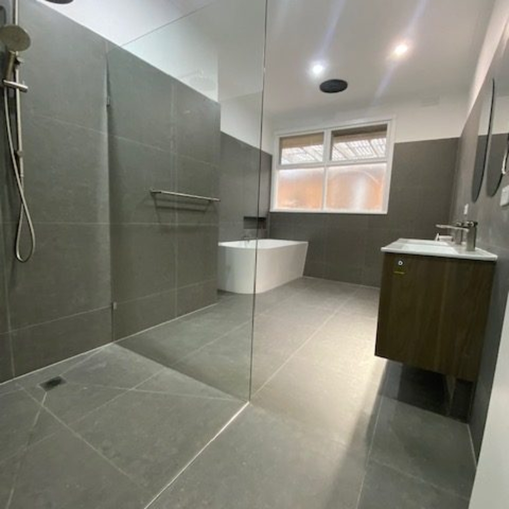 Modern bathroom with new tiles and sleek fixtures after renovation